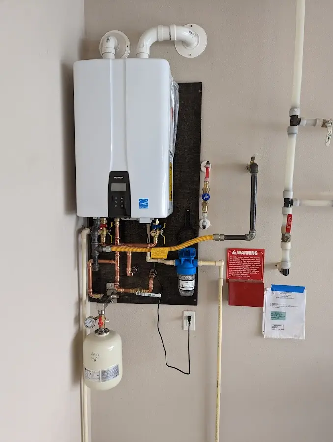 Professional plumber installing copper piping in a Lely Resort home